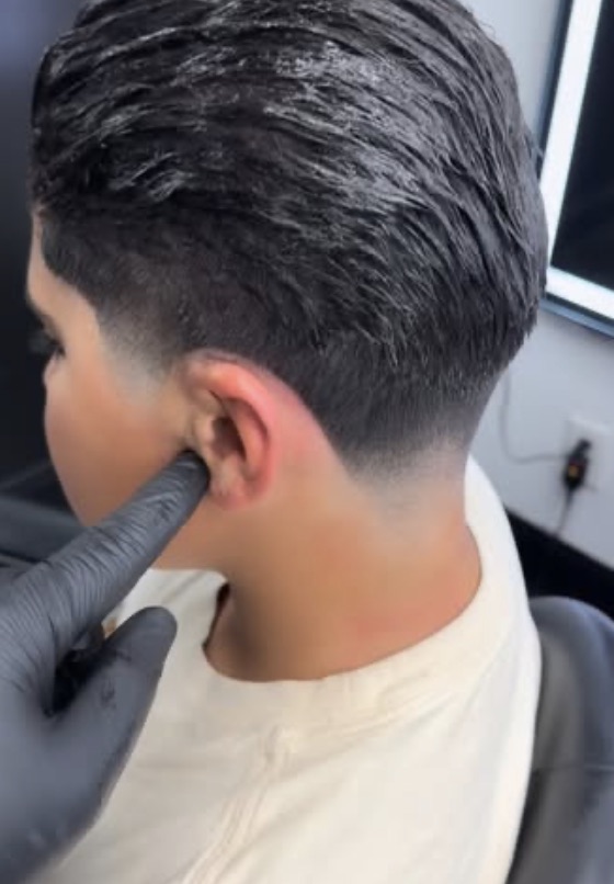 A kids&rsquo; taper cut in progress at OMI Barbershop